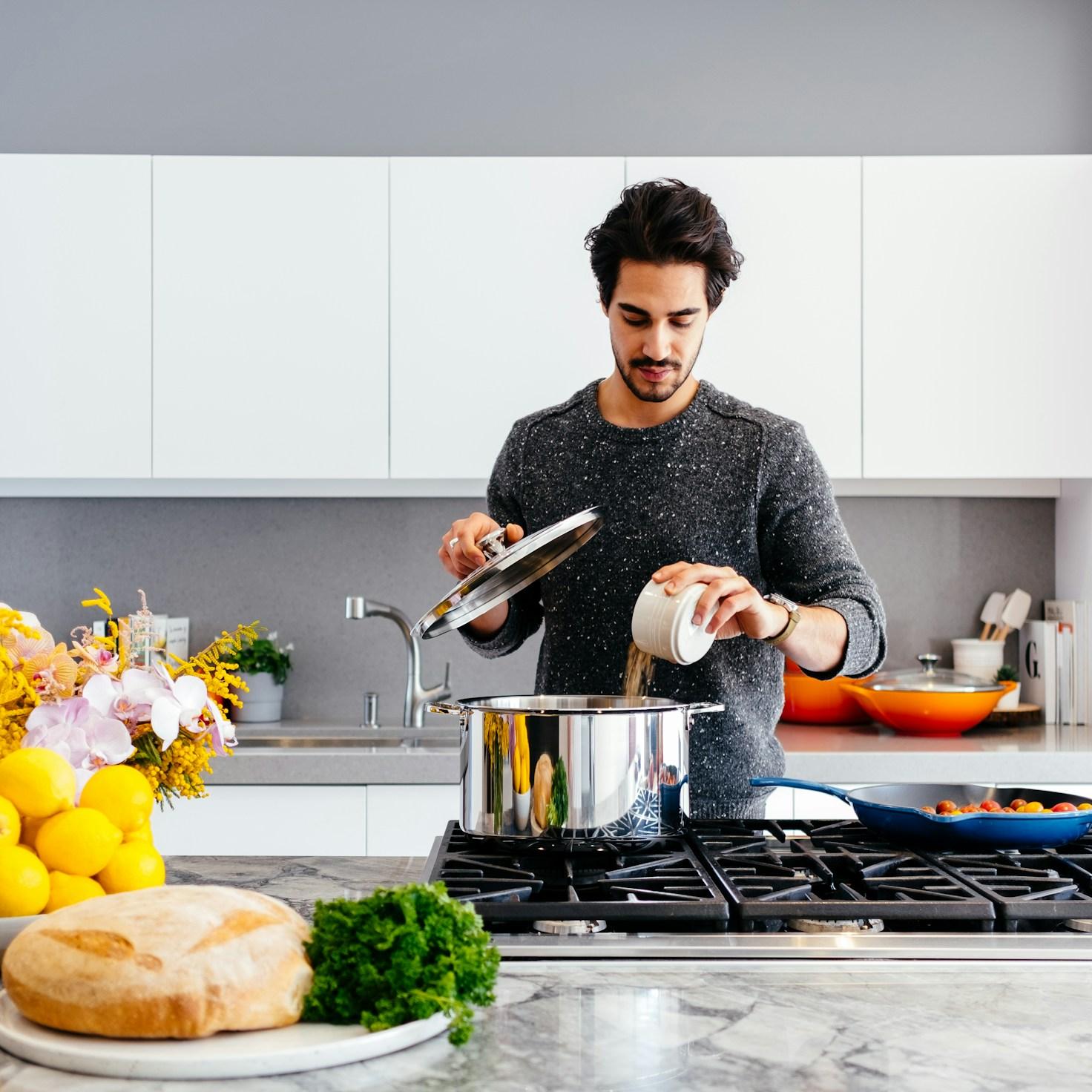 Community members collaborating in a modern kitchen space, sharing recipes and cooking techniques